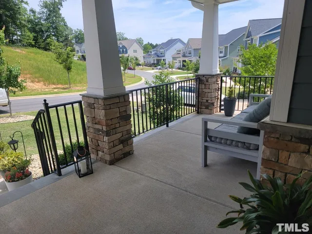 a view of a balcony with floor to ceiling windows and wooden fence