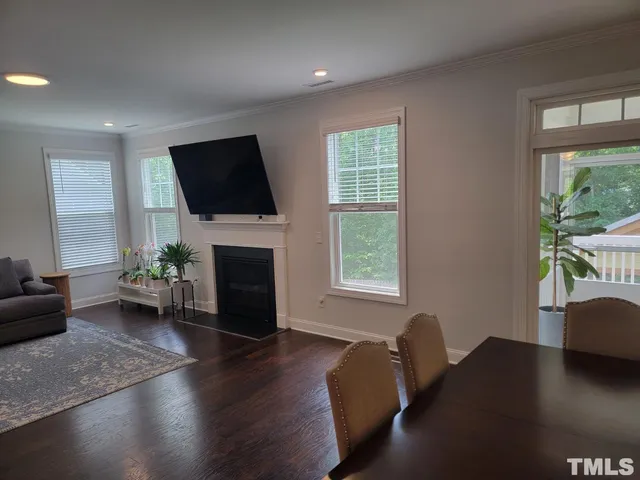 a living room with furniture fireplace and window