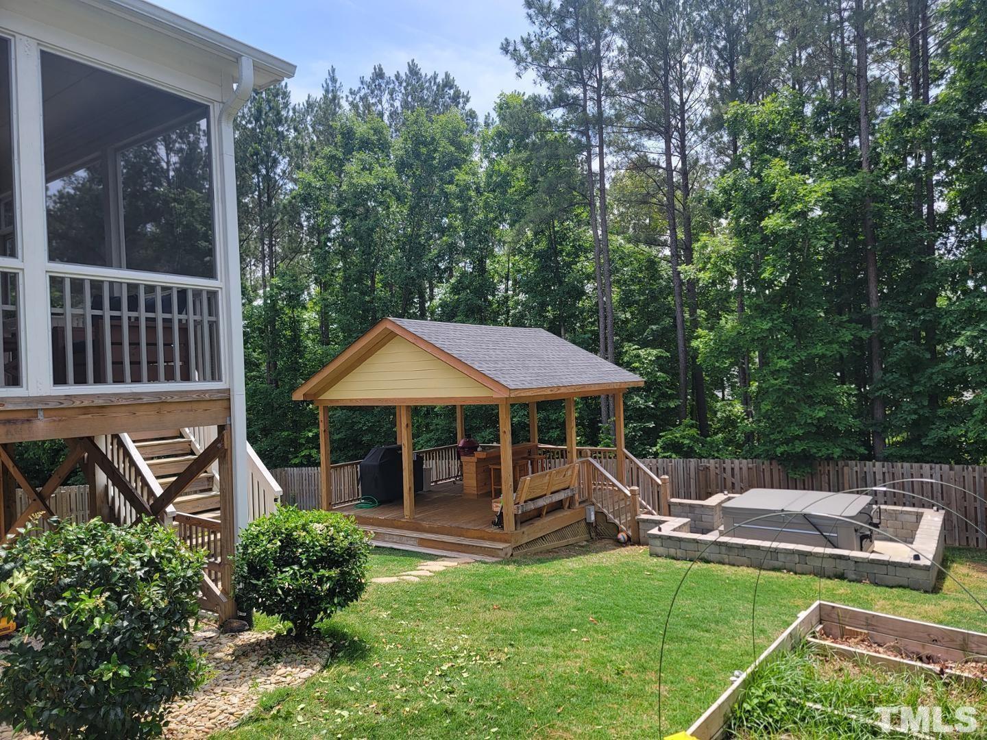 105 Winding Creek Loop Chapel Hill, NC 27517 - Photo 47 of 47 a view of a patio with table and chairs under an umbrella