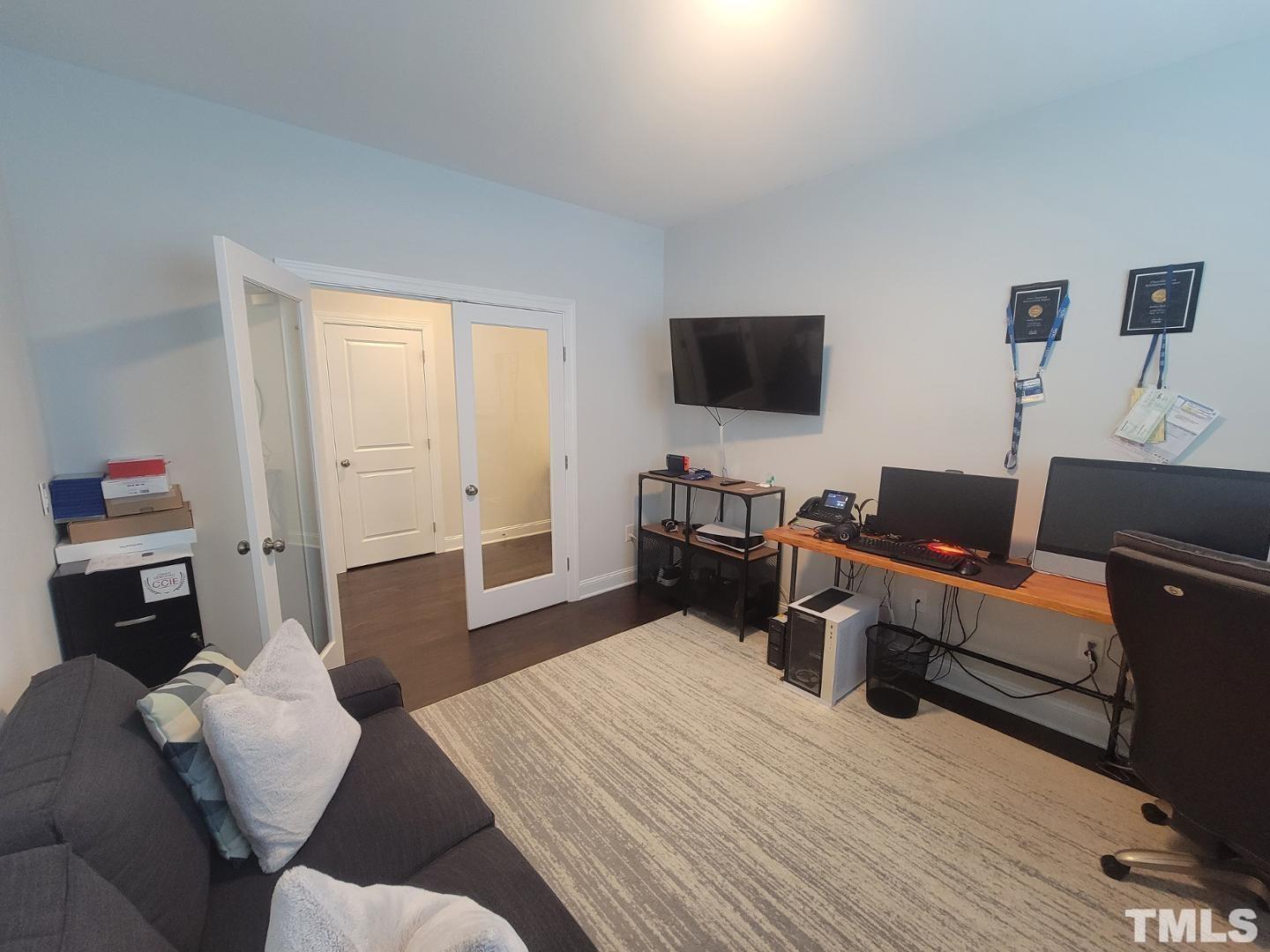 105 Winding Creek Loop Chapel Hill, NC 27517 - Photo 6 of 47 a living room with furniture and a flat screen tv