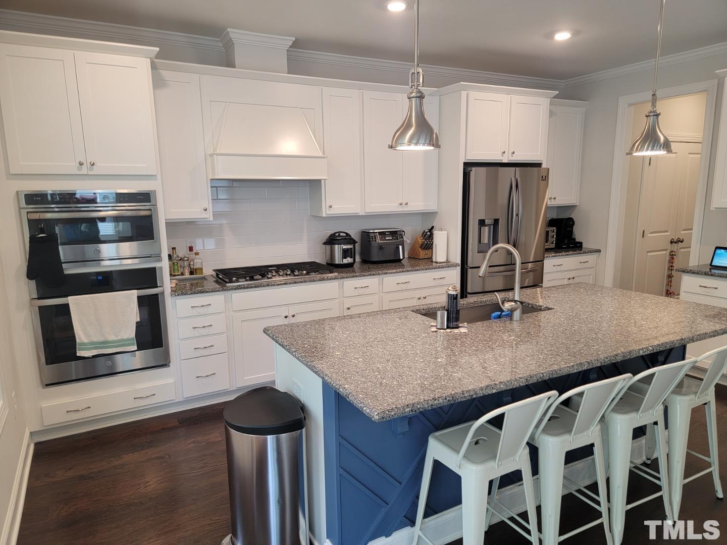 105 Winding Creek Loop Chapel Hill, NC 27517 - Photo 9 of 47 a kitchen with stainless steel appliances granite countertop a sink a stove and a refrigerator