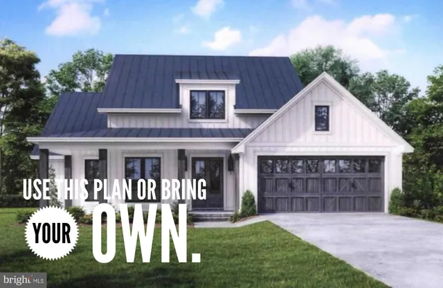 a front view of a house with yard and green space