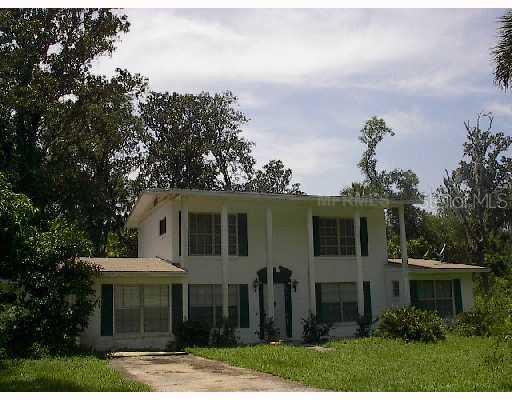 591 Lake Geneva Road Geneva, FL 32732 - Photo 1 of 1 a front view of a house with garden