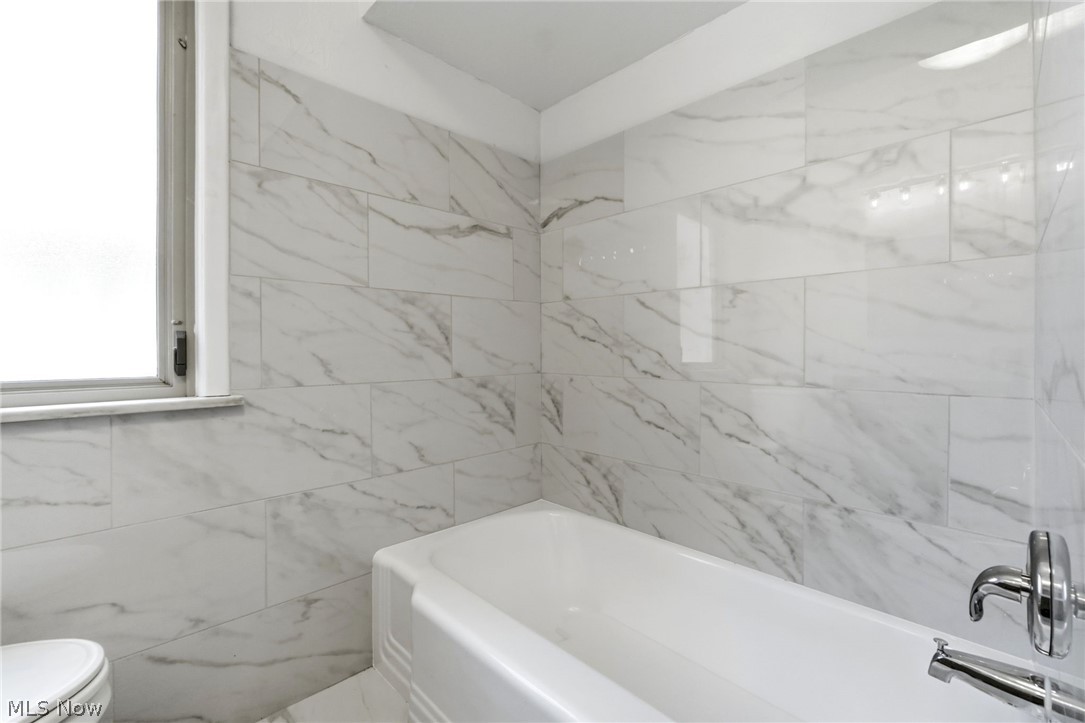2537 Edgewood Road Beachwood, OH 44122 - Photo 21 of 39 Bathtub with chrome fixtures, surrounded by large format wall tile