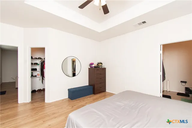 a bedroom with a bed and a chandelier