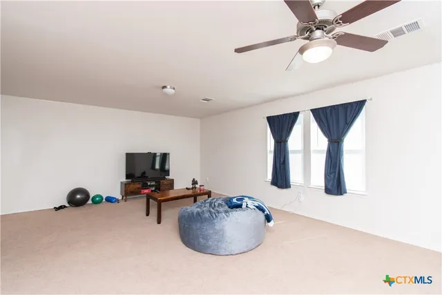 a room with a window and a ceiling fan