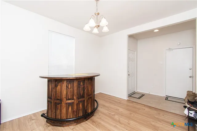 a view of a room with wooden floor