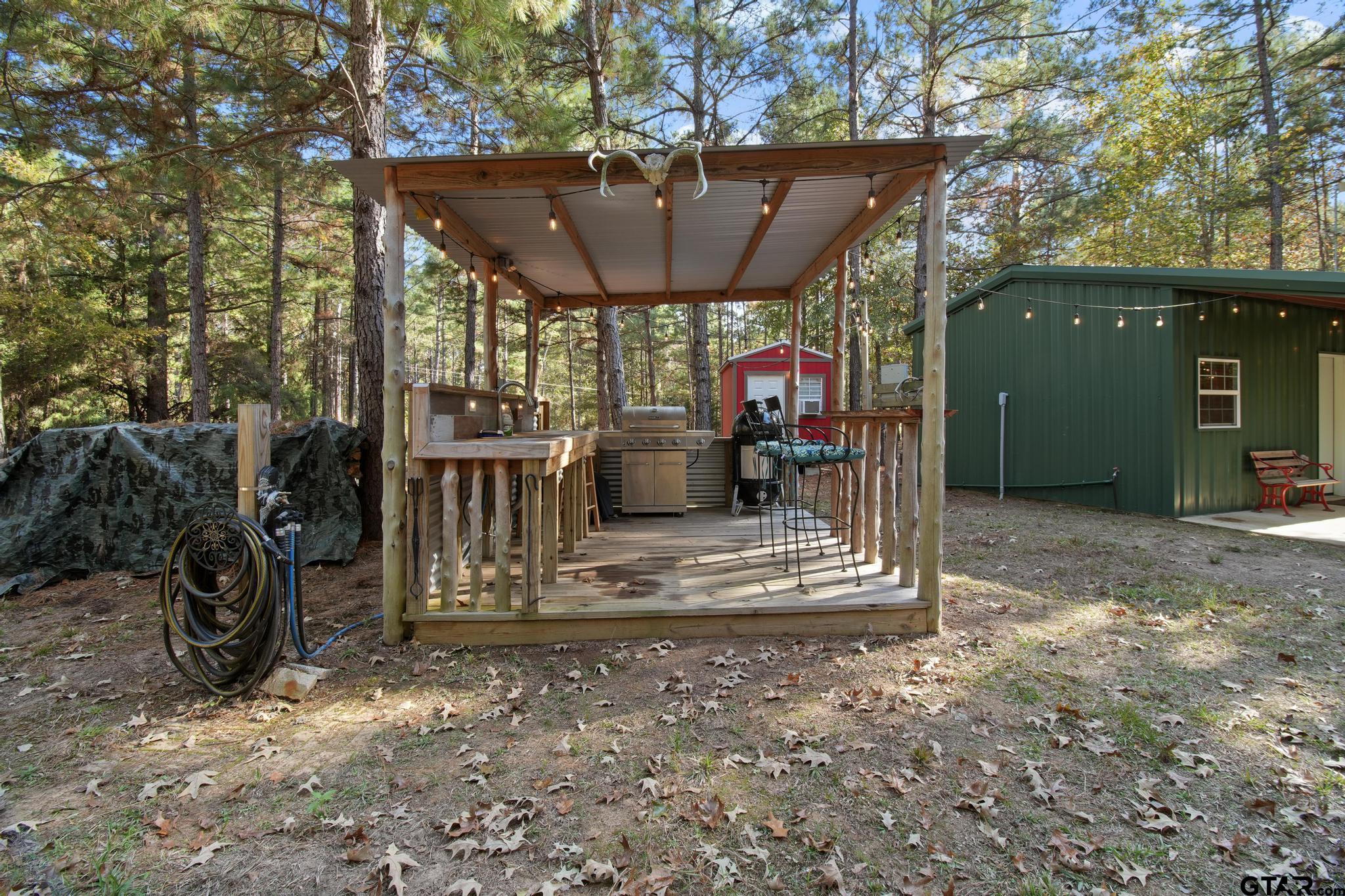 748 County Road Rusk, TX 75785 - Photo 24 of 40 a view of a patio with table and chairs under an umbrella