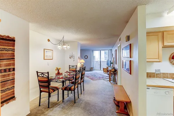 a view of a dining room with furniture and chandelier