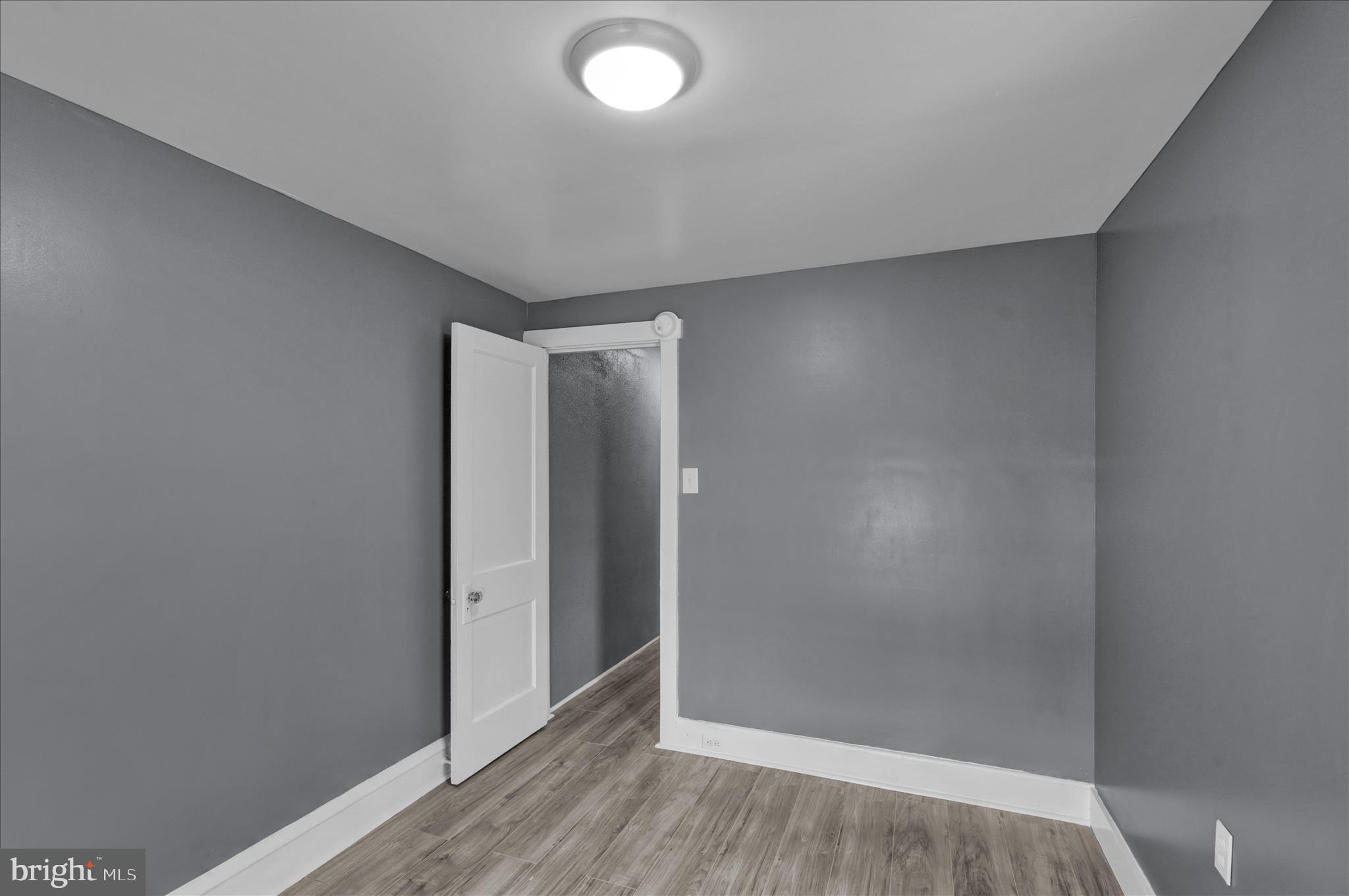 1409 Church Street Reading, PA 19601 - Photo 18 of 23 an empty room with wooden floor and entrance