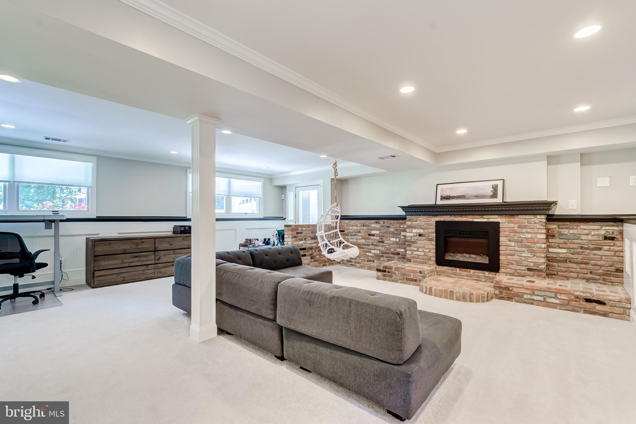 11926 Appling Valley Road Fairfax, VA 22030 - Photo 15 of 60 a living room with furniture a fireplace and a flat screen tv