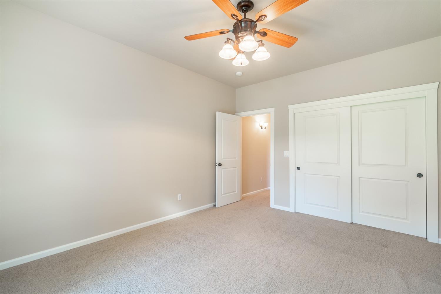 946 Pumpkin Ridge Eagle Point, OR 97524 - Photo 17 of 31 an empty room with chandelier fan