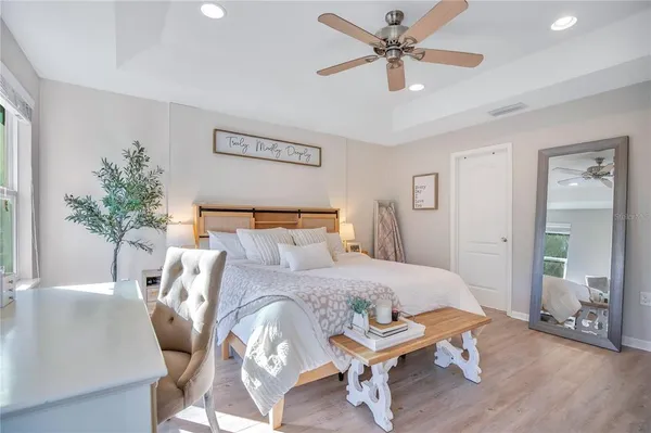 a bedroom with a bed and wooden floor