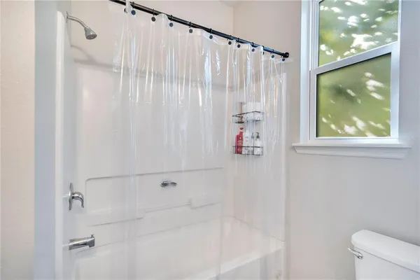 a bathroom with a shower and a tub