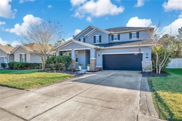a front view of a house with a yard and garage