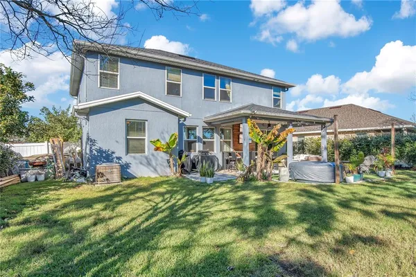a view of a house with a yard patio and sitting area