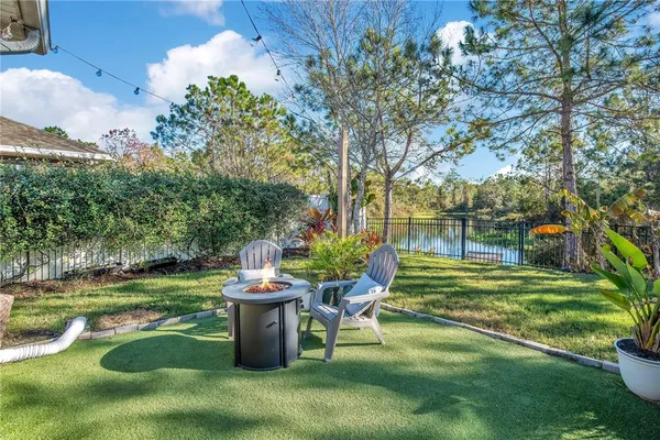 a view of a chair and table on the garden