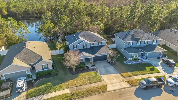 an aerial view of a house with garden space and street view