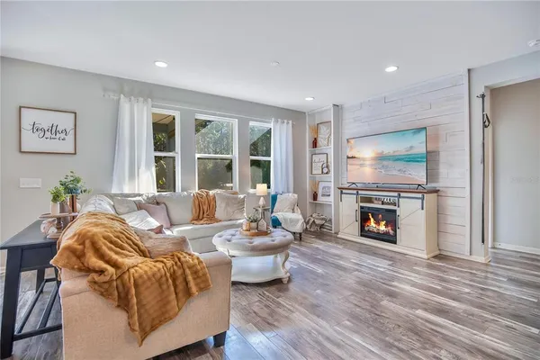 a living room with furniture and a fireplace