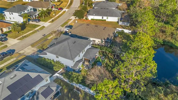 an aerial view of a house with a yard