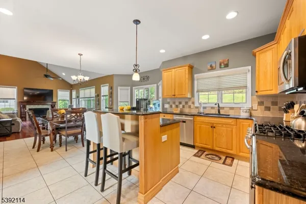 a view of a kitchen with kitchen island granite countertop lots of counter top space