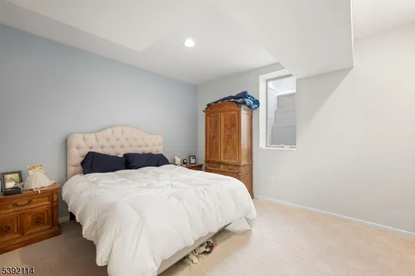 a spacious bathroom with a granite countertop toilet sink and mirror
