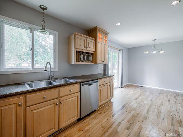 21728 Ruth Street Farmington, MI 48336 - Photo 20 of 54 Kitchen featuring light wood cabinetry, a double basin stainless steel sink, and stainless steel dishwasher