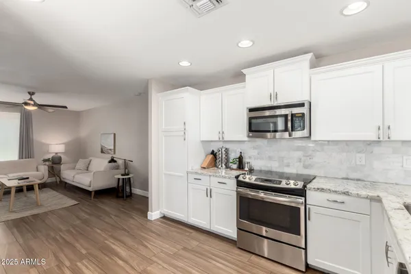 a kitchen with sink cabinets and appliances