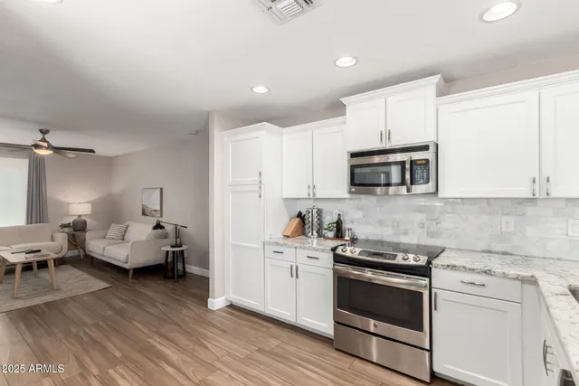a kitchen with sink cabinets and appliances