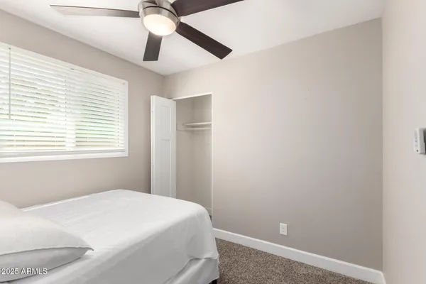 a bedroom with a bed and a window