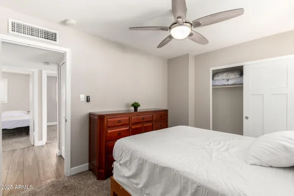 a bedroom with a bed and a chandelier