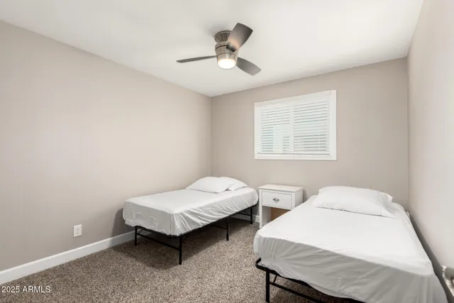 a bedroom with two beds and a window