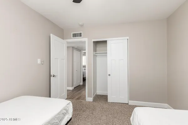 a bedroom with a bed and hallway