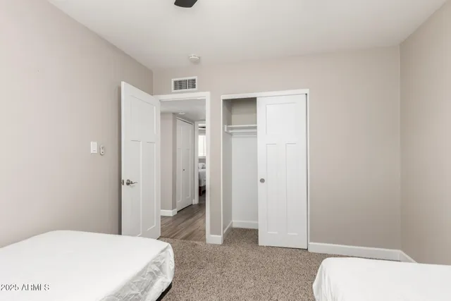 a bedroom with a bed and hallway