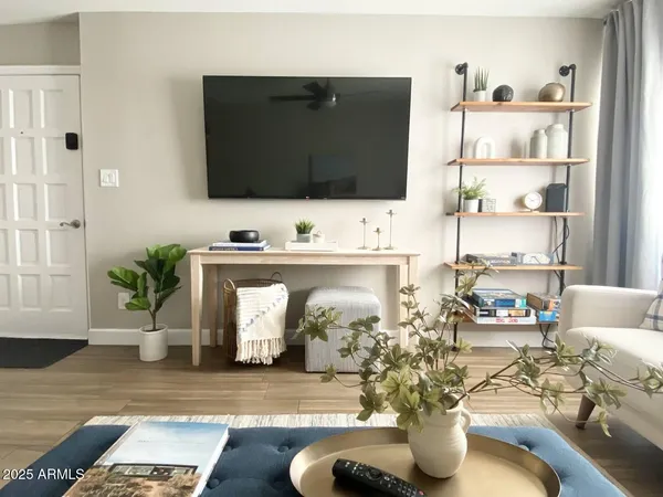 a living room with furniture and a wooden floor