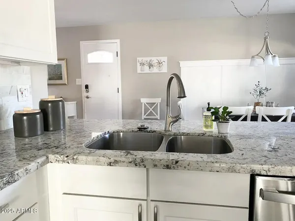 a kitchen with a counter top space a sink and cabinets
