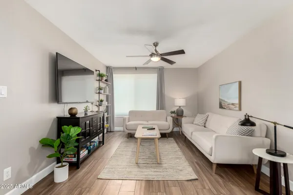 a living room with furniture and a flat screen tv