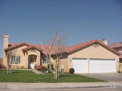3159 Quarry Road Palmdale, CA 93550 - Photo 1 of 1 a view of a white house with a yard and plants