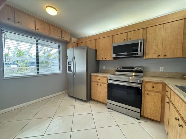 a kitchen with stainless steel appliances granite countertop a stove a microwave and a refrigerator