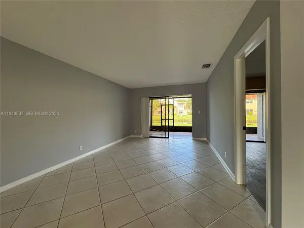 a view of an empty room with glass door