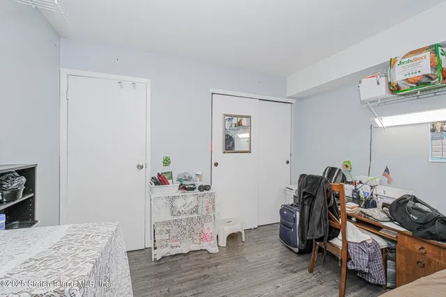 a room with a bed and wooden floor