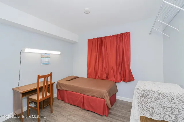 a bedroom with a bed and a chair