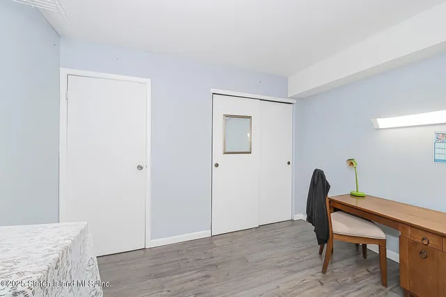 a view of a workspace with furniture and wooden floor