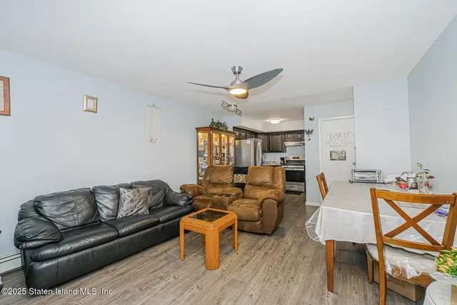 a living room with furniture a ceiling fan and a rug