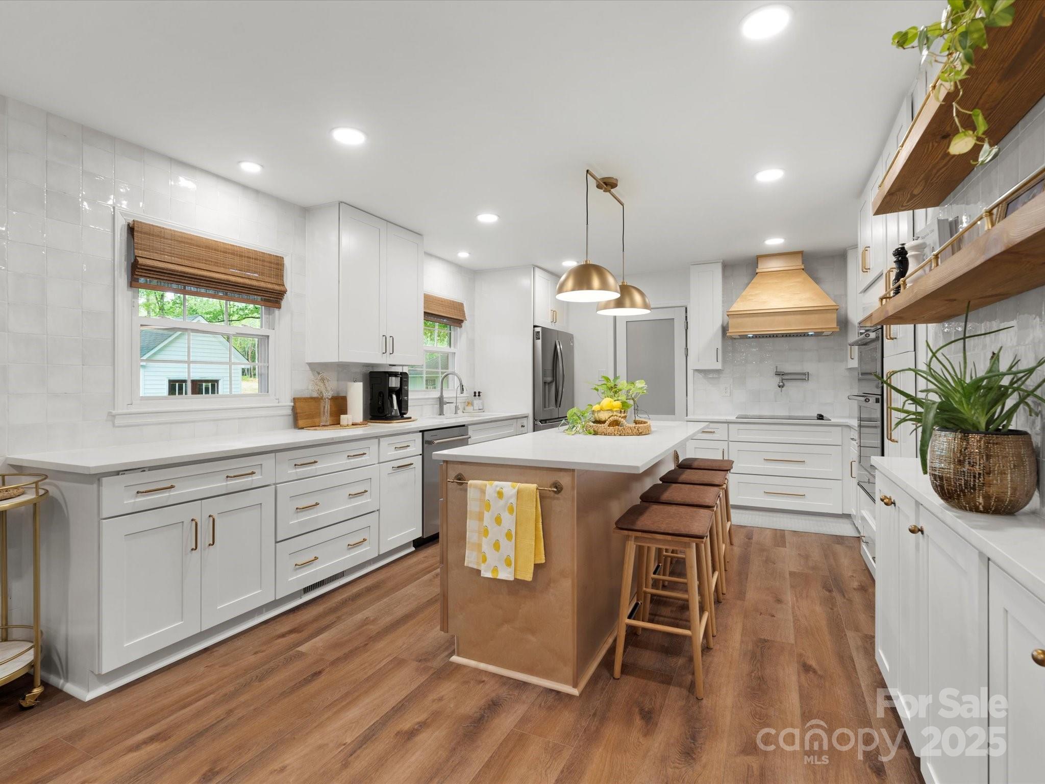 1102 Oak Hill Drive Monroe, NC 28112 - Photo 14 of 33 a kitchen with stainless steel appliances kitchen island granite countertop a stove a sink and a refrigerator