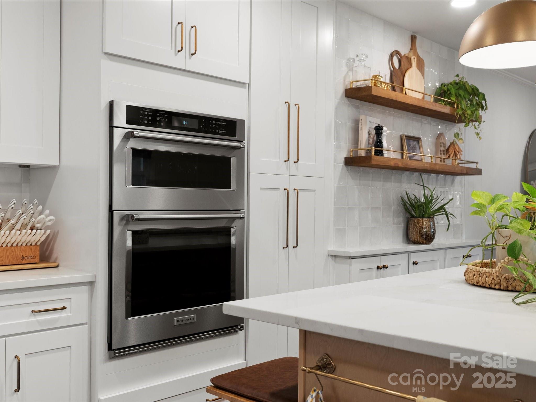 1102 Oak Hill Drive Monroe, NC 28112 - Photo 17 of 33 a kitchen with a stove and a white wooden cabinets