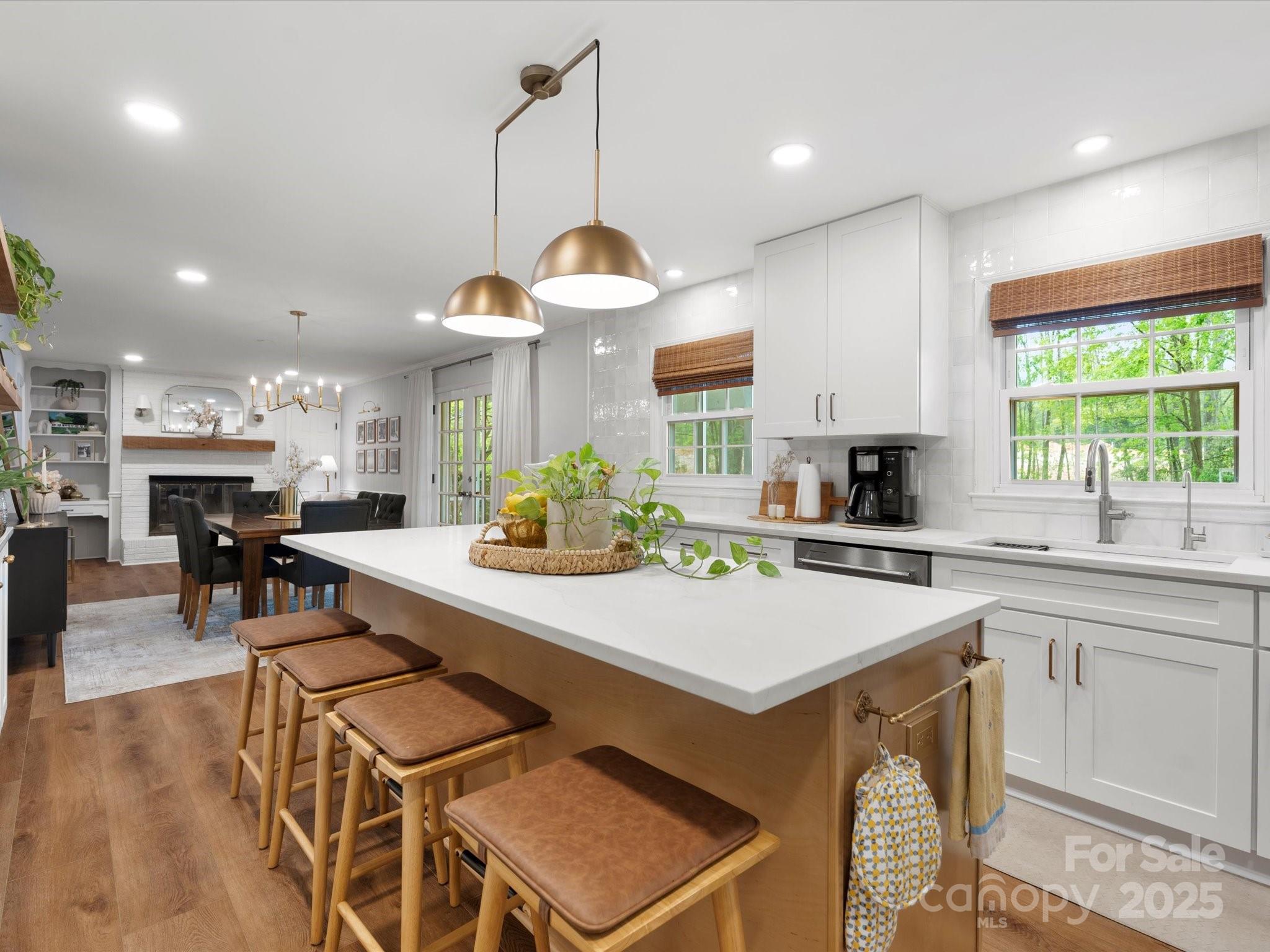 1102 Oak Hill Drive Monroe, NC 28112 - Photo 19 of 33 a kitchen with stainless steel appliances kitchen island granite countertop a stove a sink a oven a dining table and chairs with wooden floor
