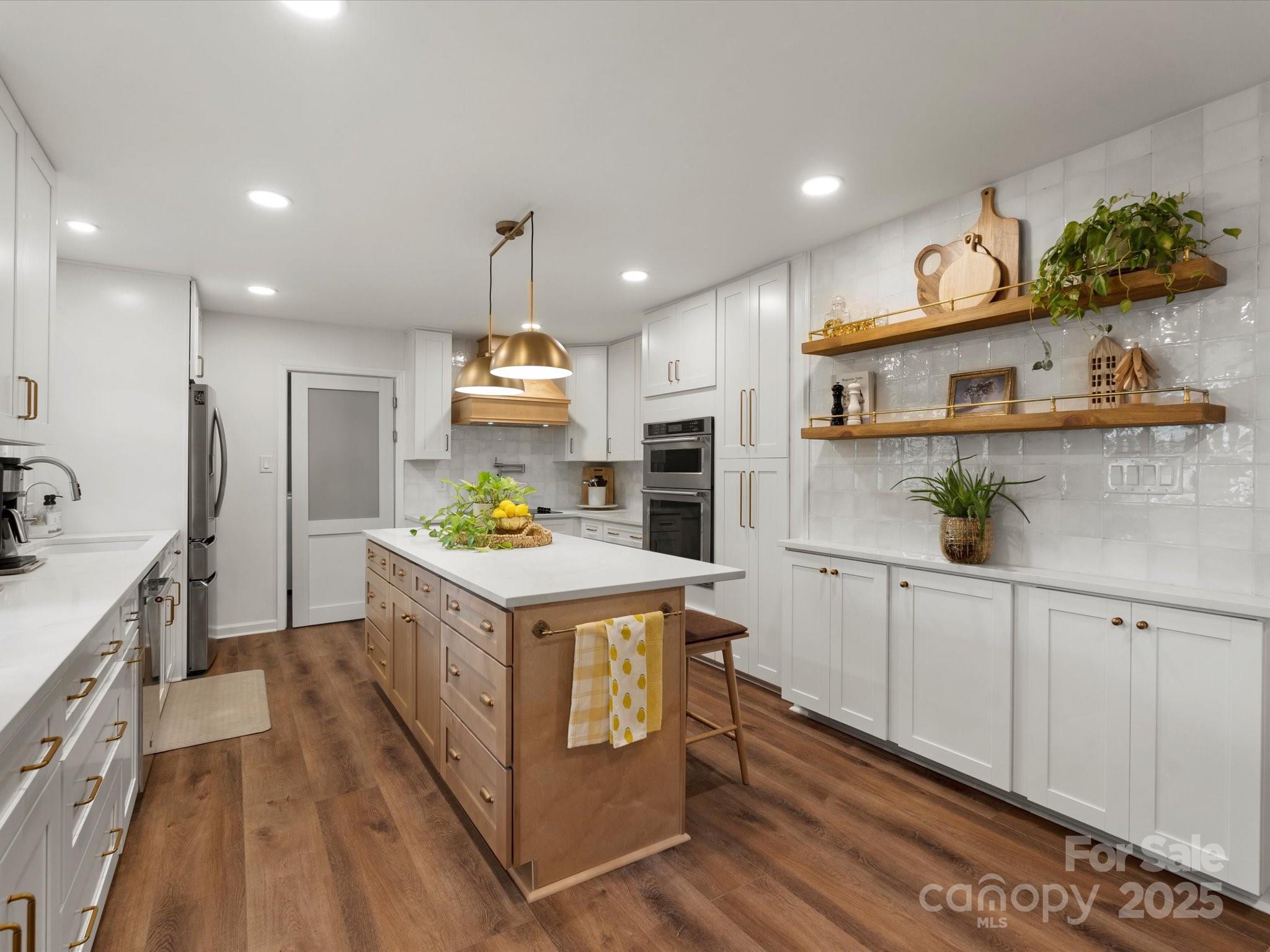 1102 Oak Hill Drive Monroe, NC 28112 - Photo 20 of 33 a kitchen that has a lot of cabinets in it and wooden floors