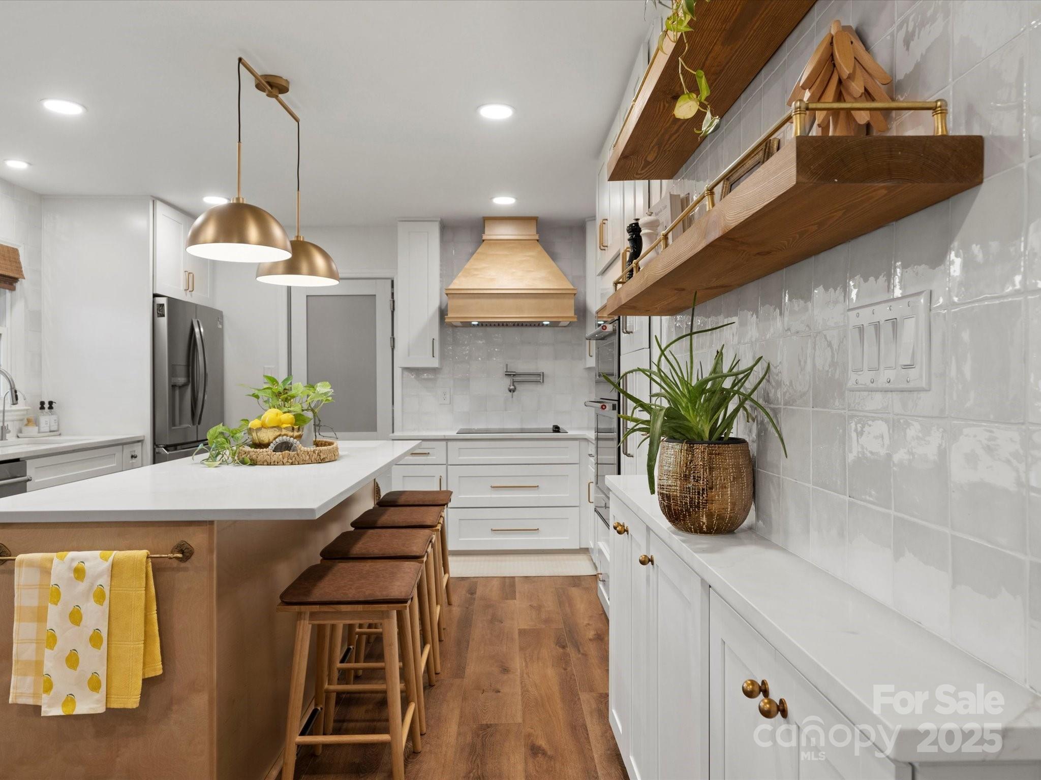 1102 Oak Hill Drive Monroe, NC 28112 - Photo 21 of 33 a kitchen with stainless steel appliances kitchen island granite countertop a sink a stove and a wooden floors