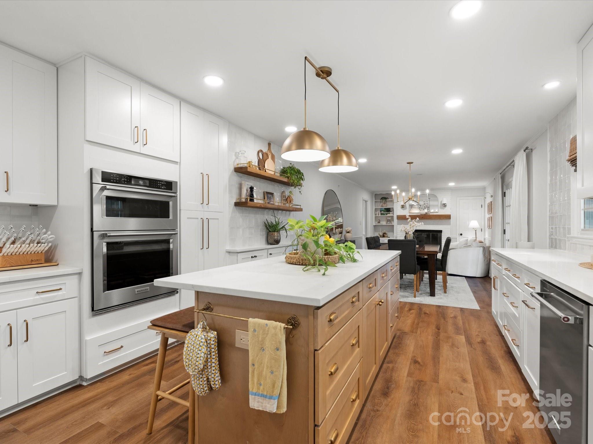 1102 Oak Hill Drive Monroe, NC 28112 - Photo 22 of 33 a kitchen with a table chairs stainless steel appliances and cabinets